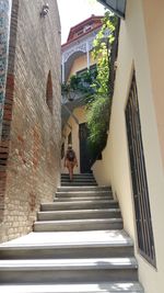 Low angle view of woman on staircase of building