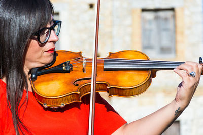 Close-up of woman playing violin