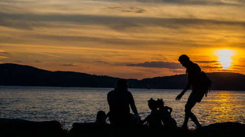 Silhouette of people at sunset
