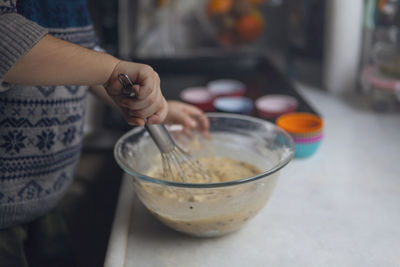 Midsection of woman preparing food on table