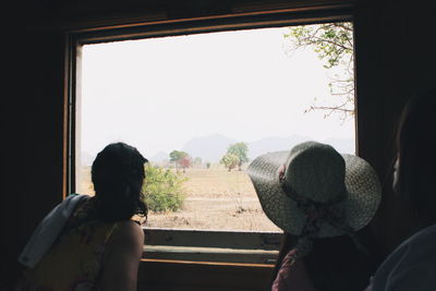 Woman looking through window