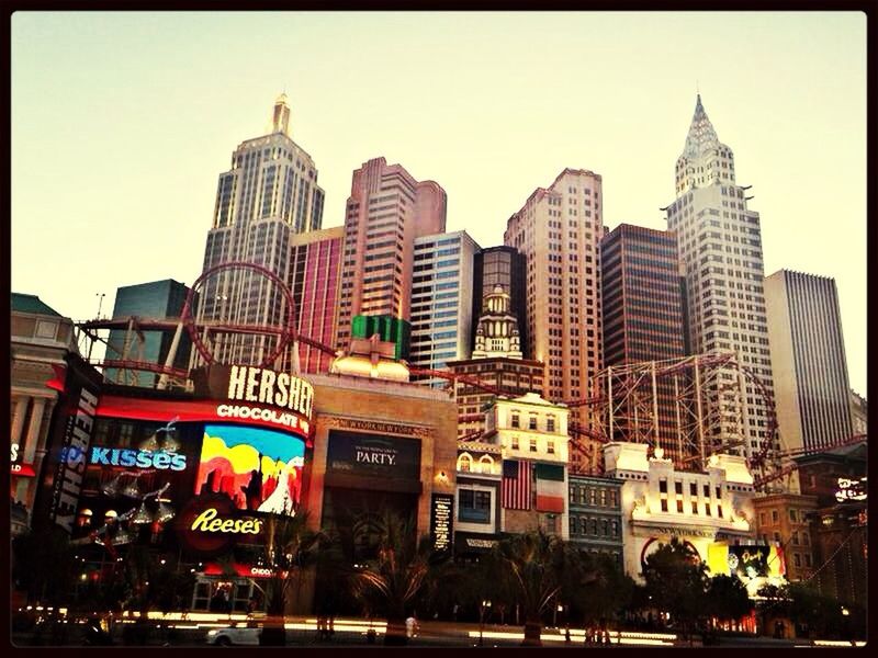 building exterior, architecture, built structure, city, transfer print, clear sky, city life, incidental people, car, auto post production filter, travel destinations, capital cities, street, famous place, travel, transportation, sky, large group of people, city street, outdoors