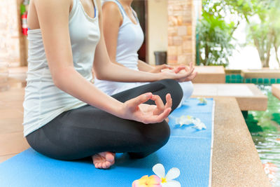 Midsection of woman sitting at home