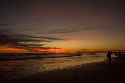 Scenic view of beach against sky during sunset