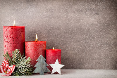 Close-up of illuminated candles on table