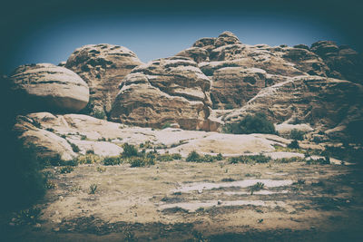 Low angle view of rocks against clear sky