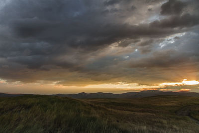 Scenic view of dramatic sky over land