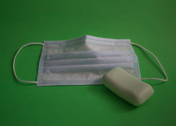 High angle view of mannequin on table against green background