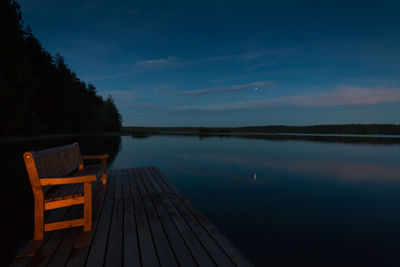 Scenic view of lake against sky at night