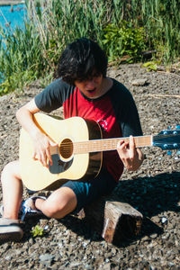 Full length of man playing guitar