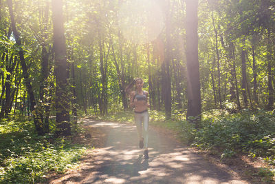 Woman amidst trees in forest