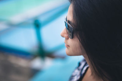 Side view of young woman wearing sunglasses