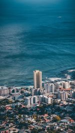 Aerial view of sea and buildings against sky