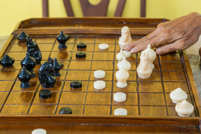 Full length of hand playing chess