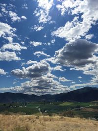 Scenic view of mountains against cloudy sky