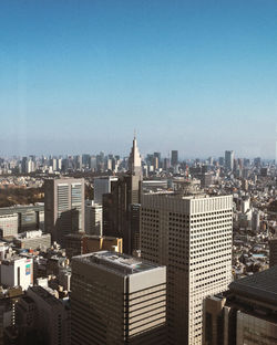 Modern buildings in city against clear sky