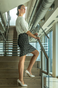 Low angle view of woman standing on staircase