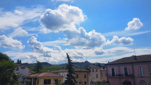 Low angle view of buildings in town against sky