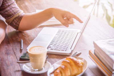 High angle view of woman and coffee cup on table