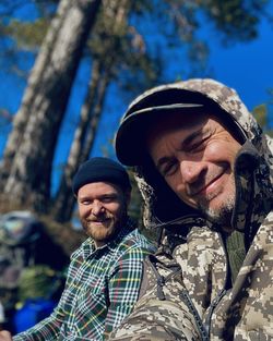 Portrait of happy men on sunny day