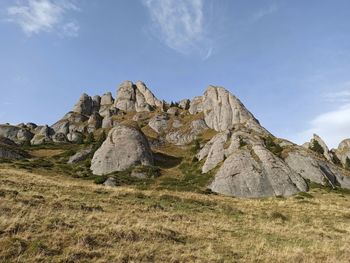 Rock formations on landscape against sky