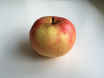 Close-up of red apple over white background