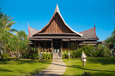 Gazebo by building against clear blue sky