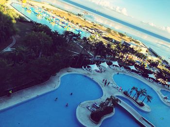 High angle view of swimming pool by sea against sky