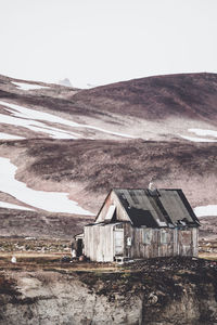 Scenic view of abandoned building and mountains against sky