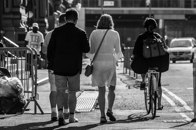 Rear view of people on footpath