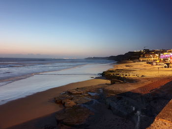 Scenic view of beach against clear sky