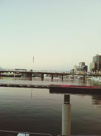 Bridge over river with buildings in background