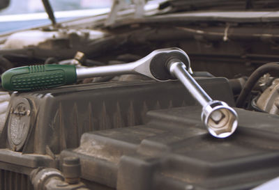 Close-up of adjustable wrench on car engine