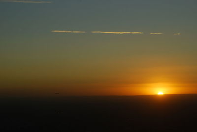 Scenic view of vapor trails in sky during sunset