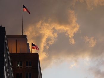 Low angle view of flag against cloudy sky