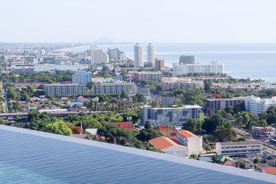 High angle view of buildings and sea against sky