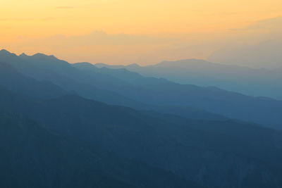 Scenic view of mountains against sky during sunset