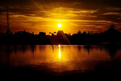 Scenic view of silhouette trees against orange sky