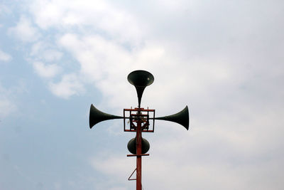 Low angle view of megaphones against sky