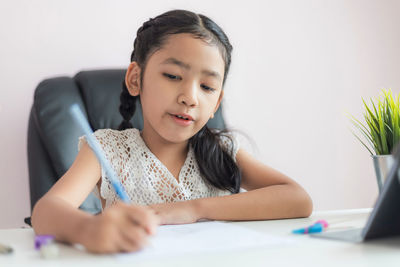 Portrait of a girl sitting on table