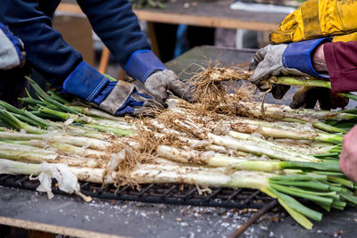 Low section of man preparing food at market