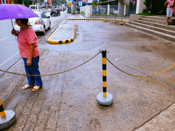 Woman standing on city street