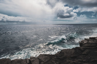 Scenic view of sea against sky with rock in foreground. taken at volcano national park in hawaii.