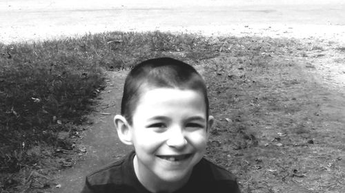 Portrait of boy smiling on field