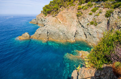 Rock formations by sea against sky