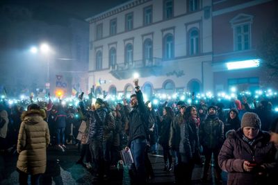 Crowd at illuminated city at night