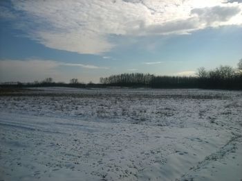 Scenic view of landscape against sky during winter