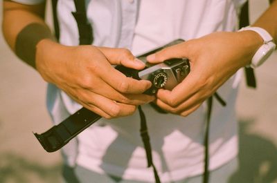 Midsection of man holding mobile phone