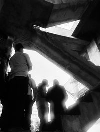 Rear view of men sitting on ceiling