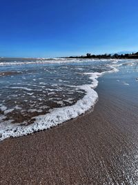 Scenic view of sea against clear blue sky